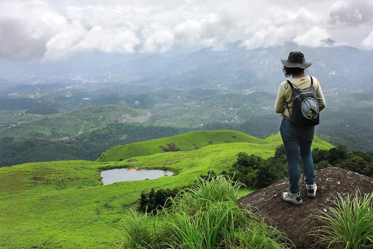 Trekking trail in Wayanad hills with misty backdrop